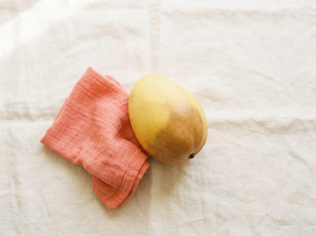 A large mango, the size of a baby at week 23